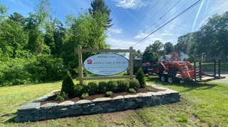 Sign planting and wall in Westfield was designed and installed by Eich Bros Landscaping